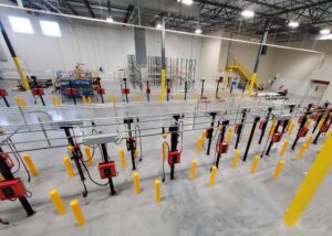 Park and charge system featuring opportunity charging in a distrubtion center